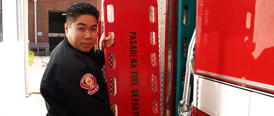 An EMS Reserve member beside a Pasadena Fire Department rescue ambulance
