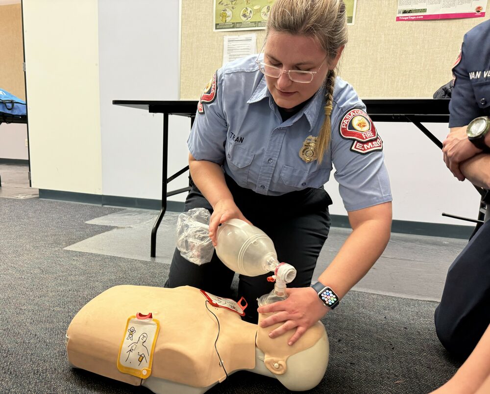 An EMS Reserve member practicing CPR and bag-valve-mask ventilation on a manikin