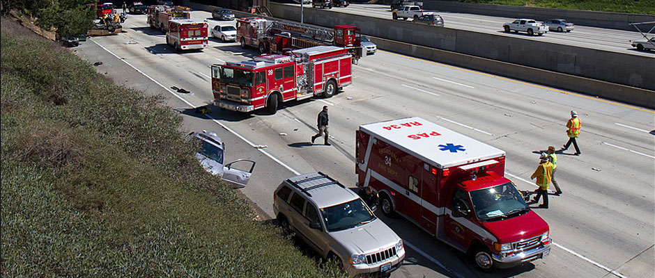Fire engines and a rescue ambulance at a freeway traffic collision