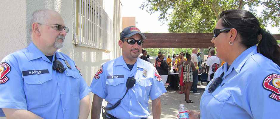 Three EMS Reserve members talking at a community event