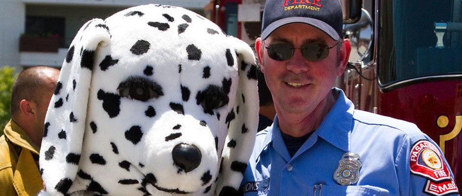 An EMS Reserve member with the fire department's Dalmatian mascot