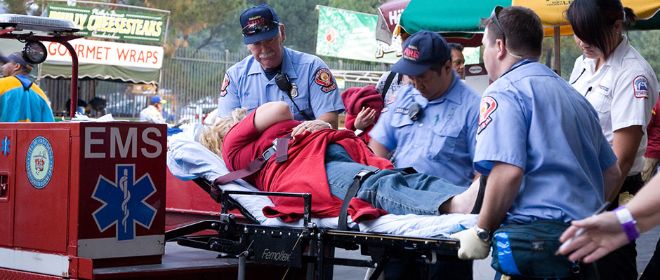 EMS Reserve members transporting a patient on a gurney at an event