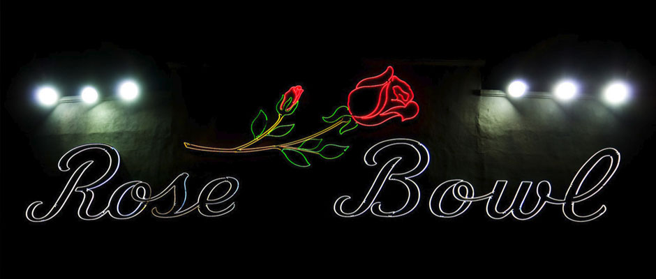 The illuminated Rose Bowl neon sign at night